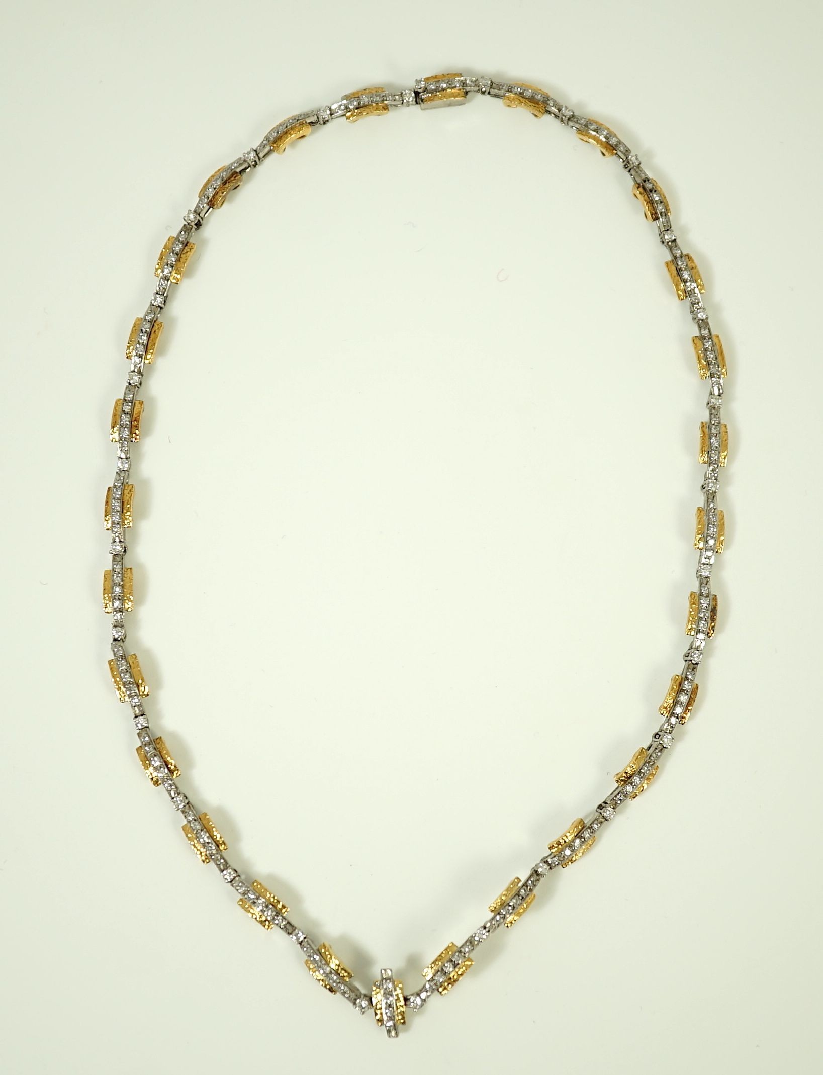 A 20th century two colour gold and diamond set necklace